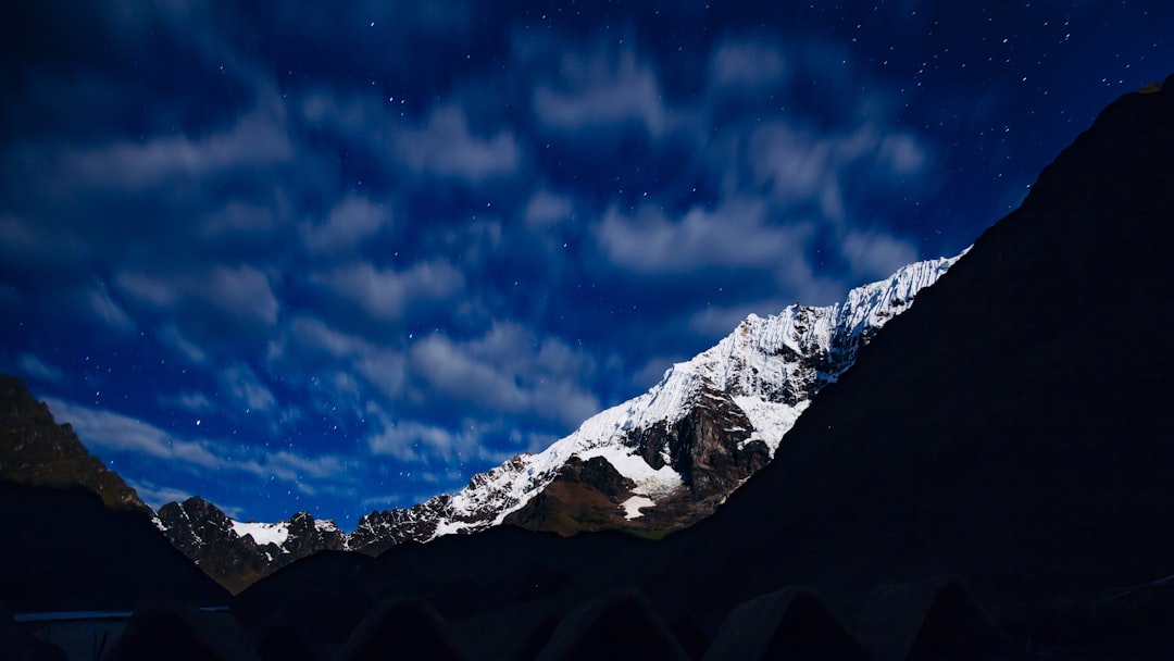 low-angle photo of mountain covered snow