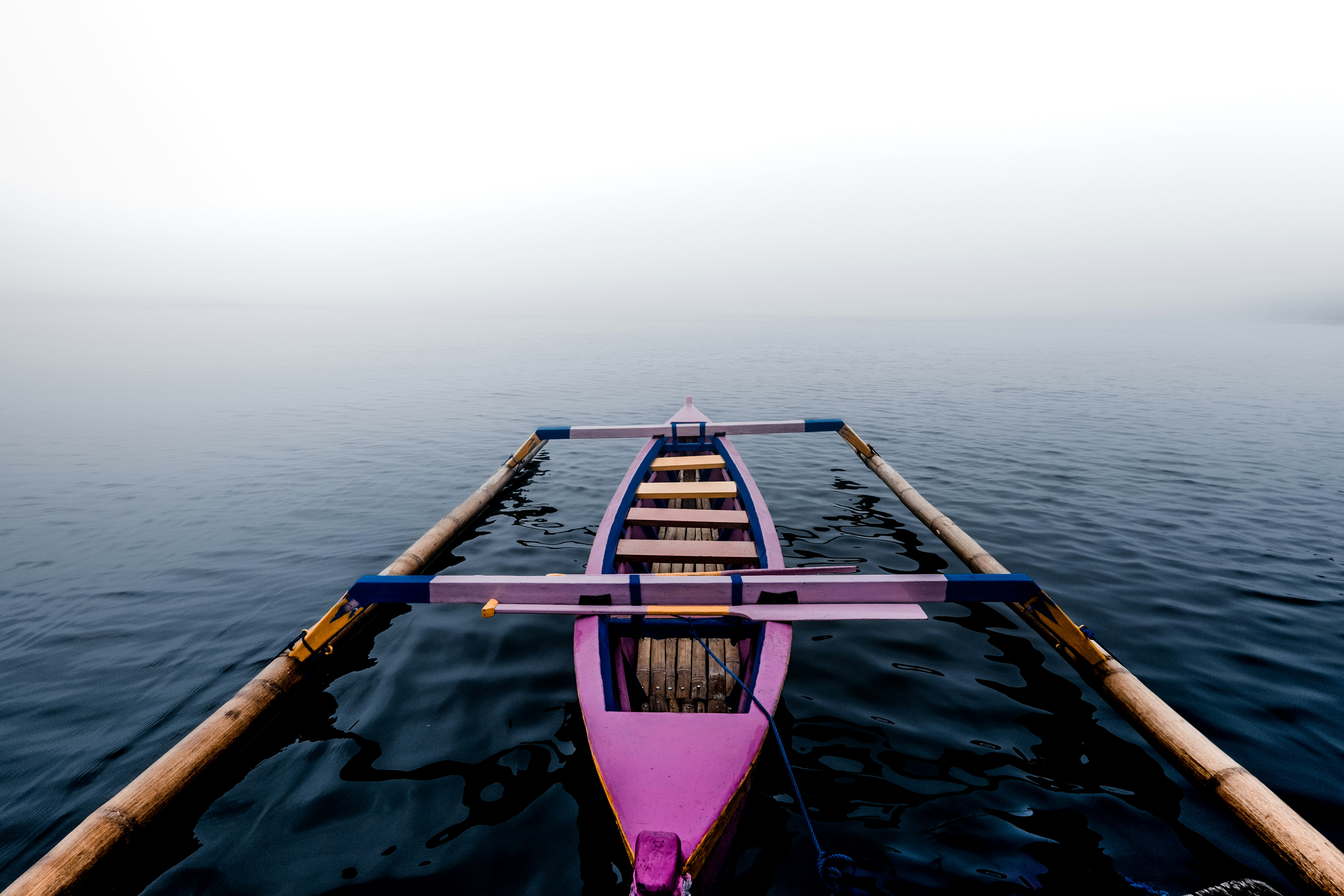 pink kayak on body of water