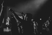 Black and white artistic shot of a Latin festival crowd immersed in the music.