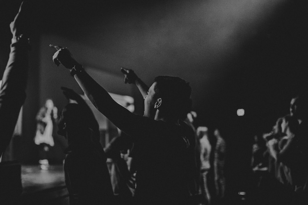 people at concert, guy worshipping