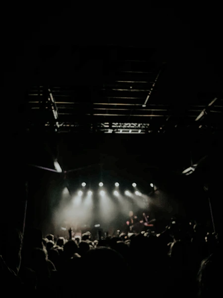 Stage performance with audience in dark theater