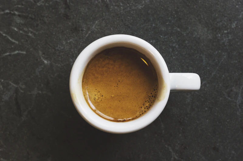 Espresso shot in white cup — MLK Deli