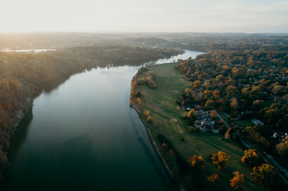 aerial photo of body of water between forests