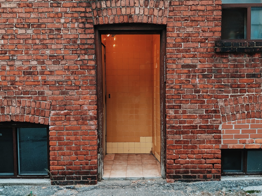 opened door of brown brick building