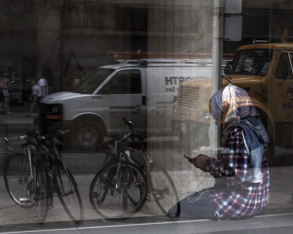 person in gray hijab sitting near glass