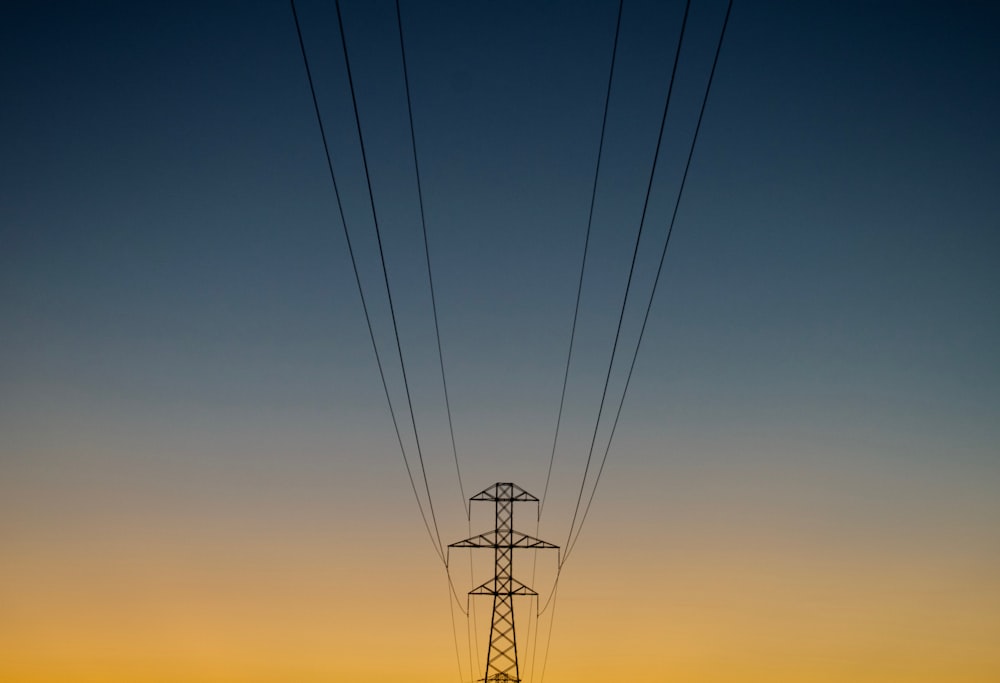 gray utility post during golden hour