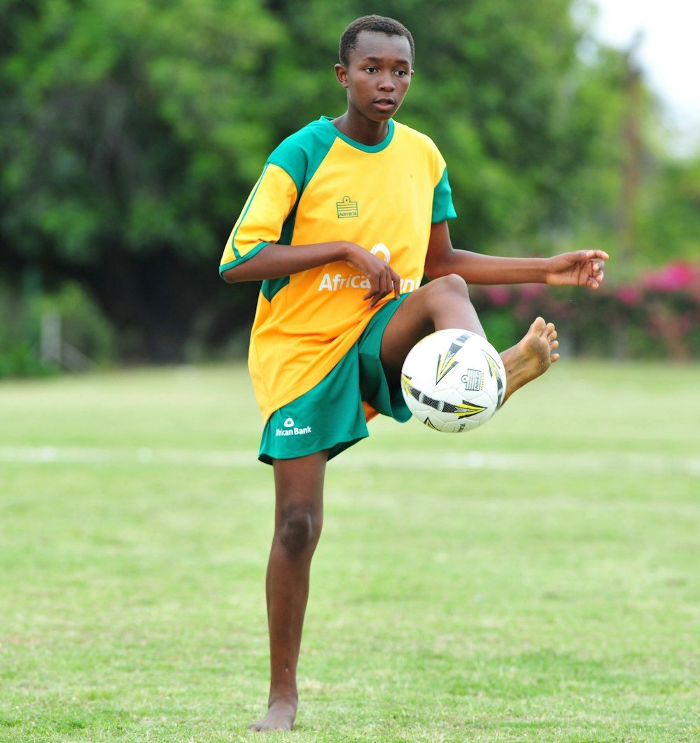 boy playing soccer ball