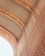 An intricately designed architectural element features detailed geometric patterns and ornate calligraphy in a symmetrical layout. The arches and carvings exhibit a high level of craftsmanship and artistry, with a focus on elegance and precision.