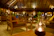 A warm, sunlit lounge area with plush seating and elegant natural decor, inviting relaxation.