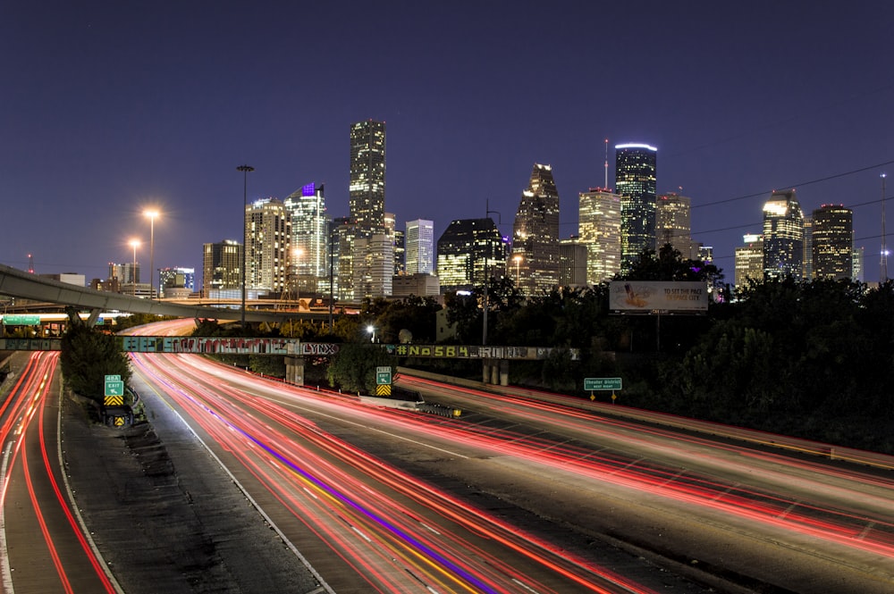 time lapse photography of vehicle traveling with a speed of light in road