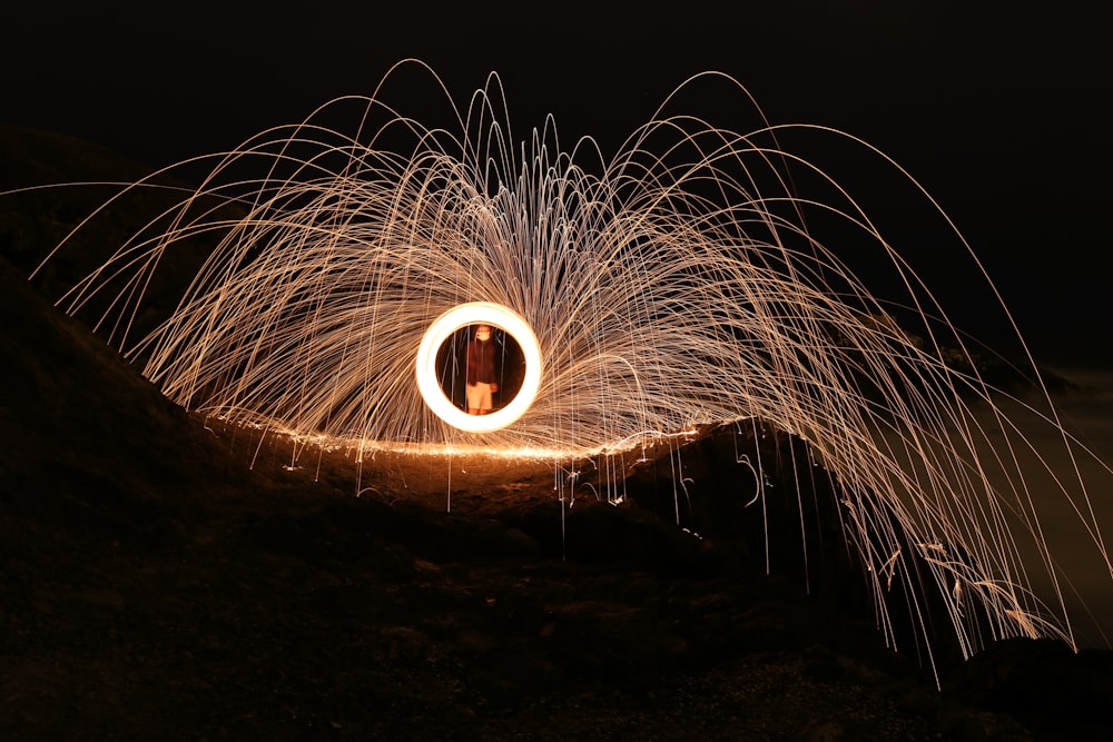 person perfoming fire dancing during daytime