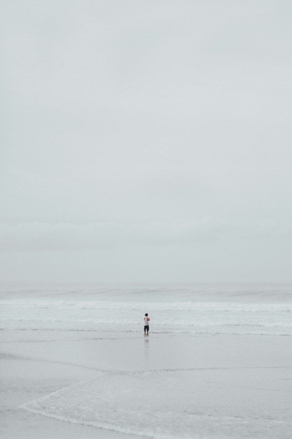 person in middle of seashore