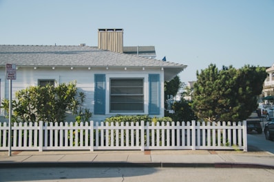 Cozy single-family house with a white picket fence and garden.
