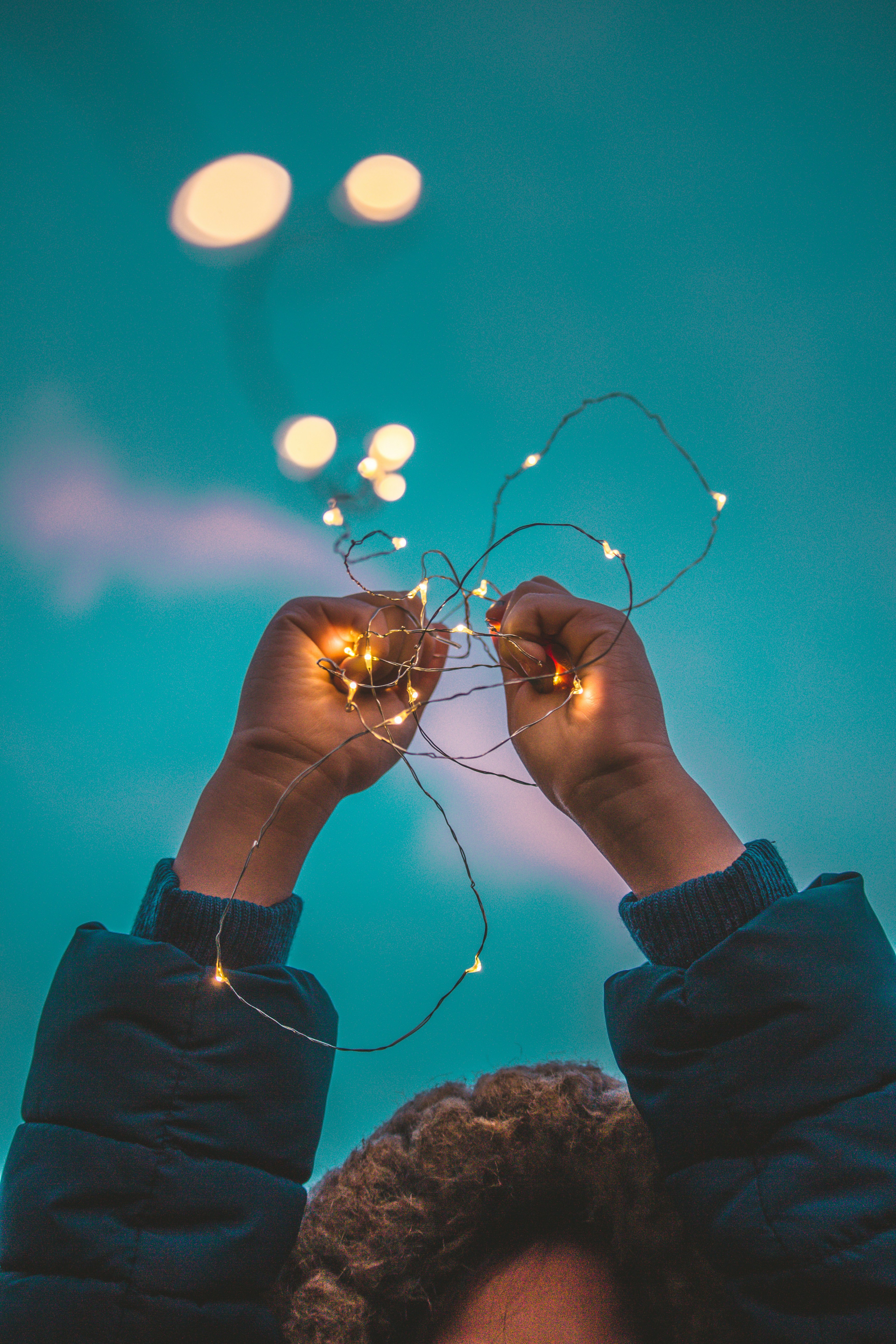 Person holding up a yellow string light photo – Free Saint paul ...
