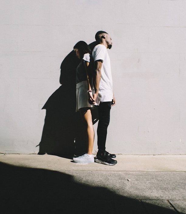 couple leaning on wall