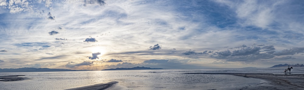 body of water under cloudy sky