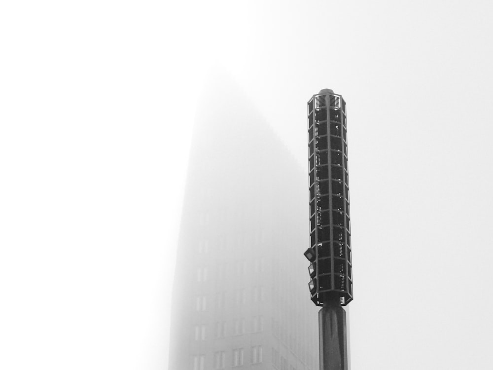 close-up photography of black street post against high rise building