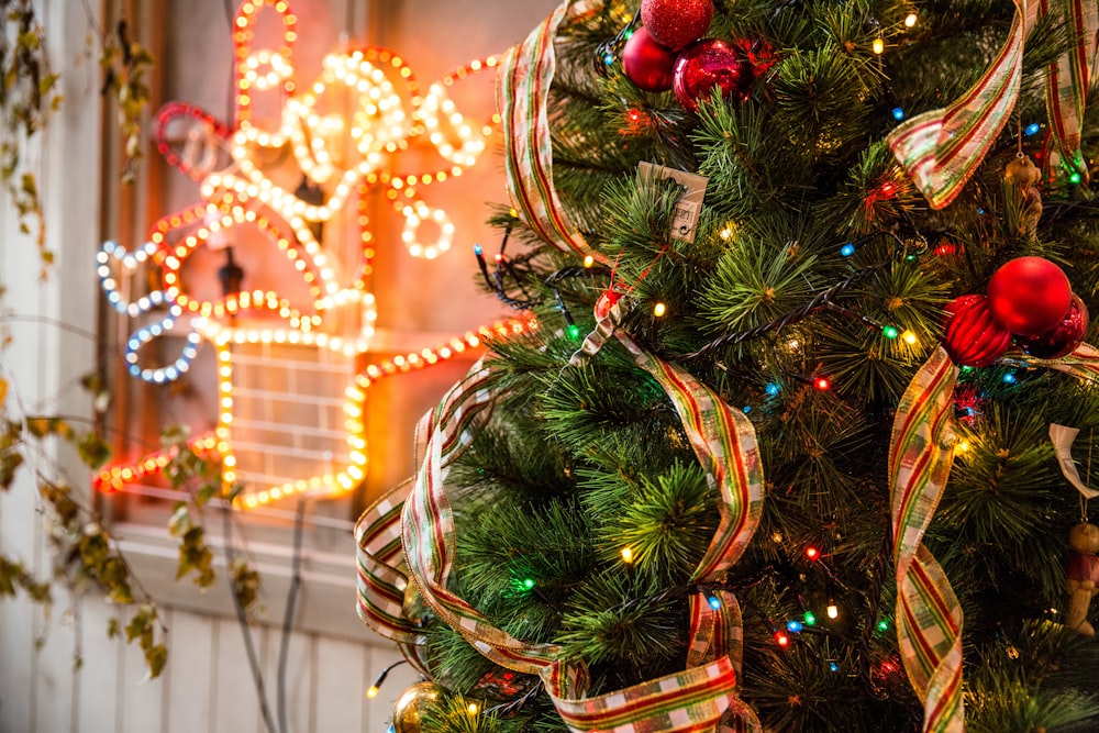 green and red Christmas tree near yellow neon light