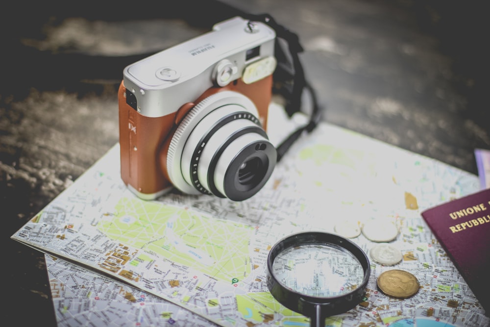 silver point-and-shoot camera on geographical map