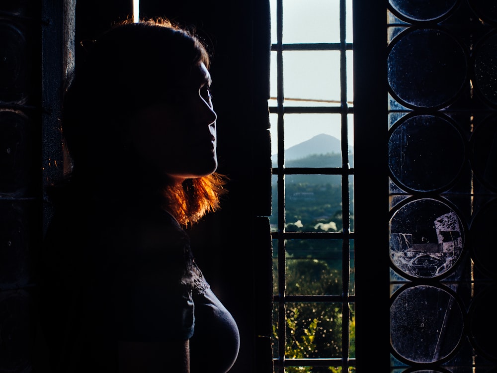 woman leaning wall taken inside room