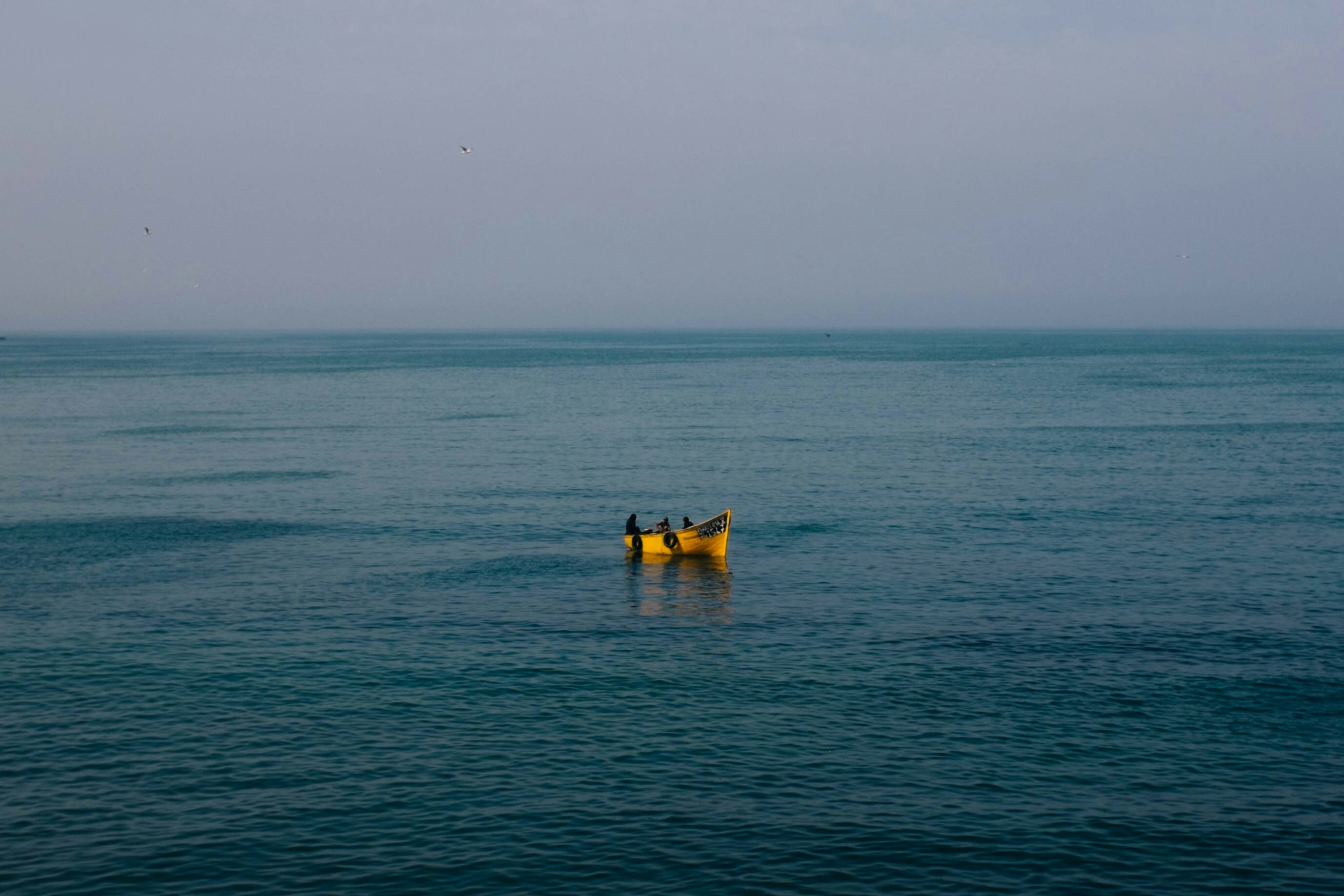 landscape photography of yellow floater floating on sea, Taken whilst on my honeymoon sitting at the end of the port wall in Essaouira.