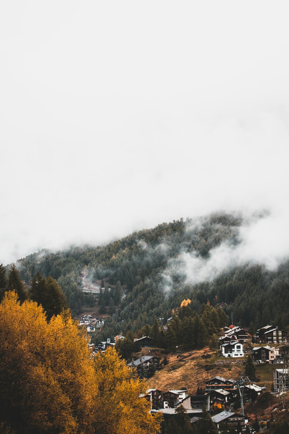 assorted houses beside mountain during daytime