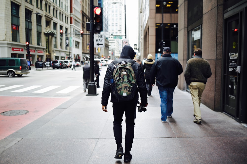 men walking on pathway beside building