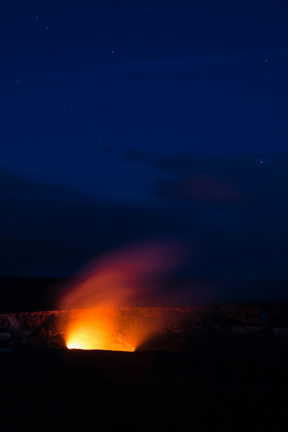 focus photography of red and orange light at night