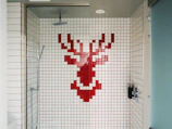 Close-up of custom glass shower box with polished chrome fixtures.