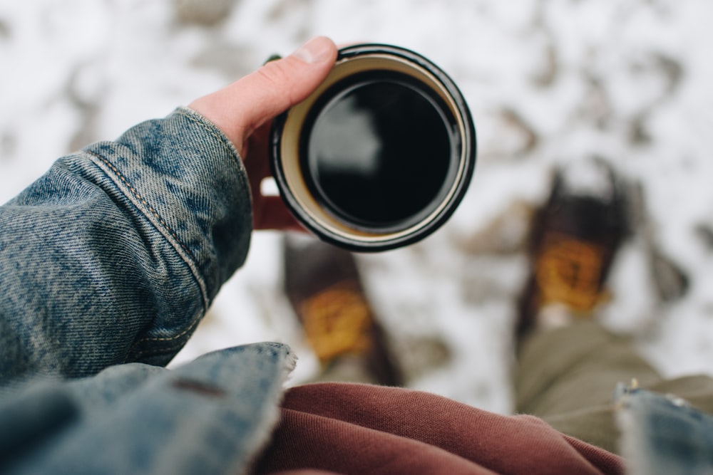 person holding mug