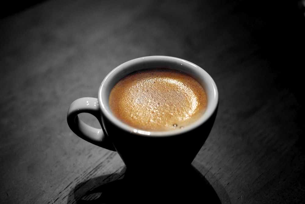 white ceramic coffee mug with capuccino