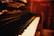 A close-up of a piano with sheet music and a warm light illuminating the keys.