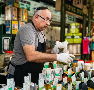 man selling assorted seeds