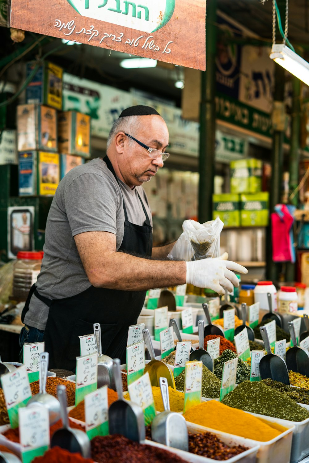 man selling assorted seeds