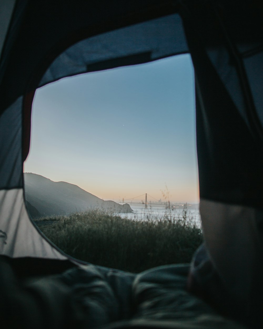 gray and white tent near body of water