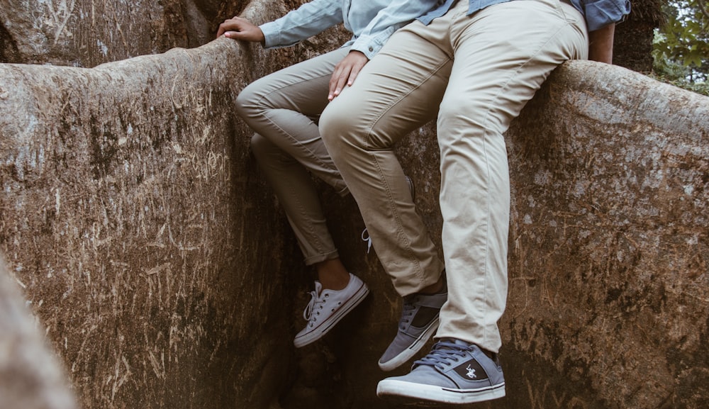 two person sitting on brown surface