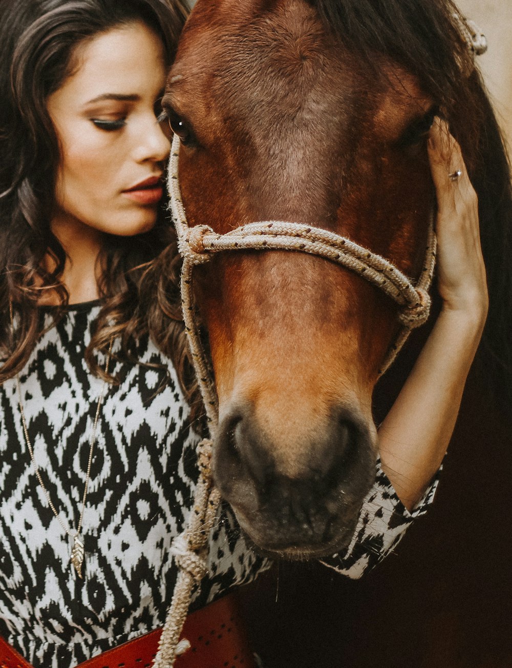 woman holding horse head