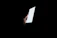 A serene phone handset glowing softly against a dark background.