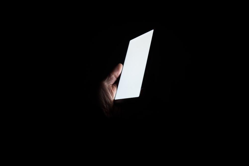person holding smartphone at night