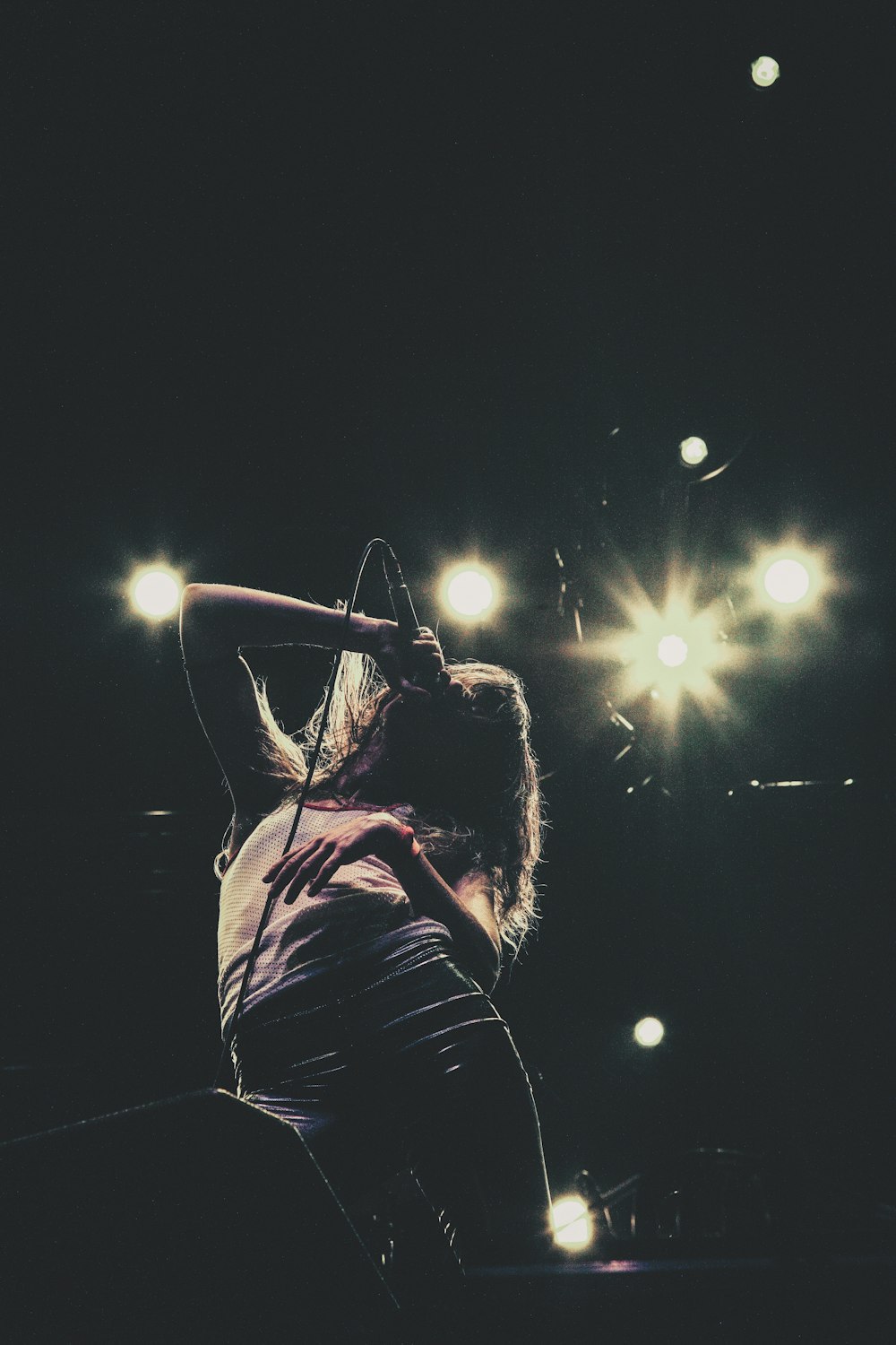 silhoutte of woman holding microphone