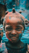 girl covered with holi powder during daytime