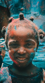 girl covered with holi powder during daytime