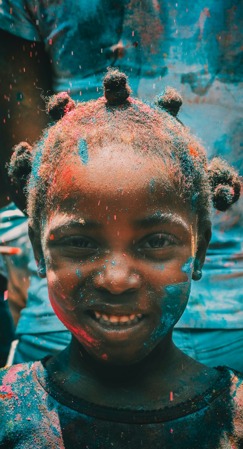 girl covered with holi powder during daytime