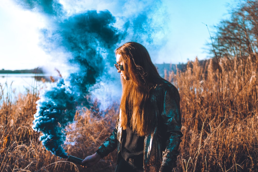 woman holding smoke tool