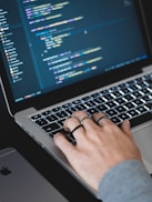 person typing on turned on MacBook
