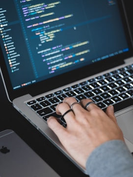 Close up picture of a programmer typing into a code editor