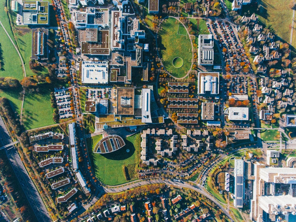 aerial view of buildings and green grass fields