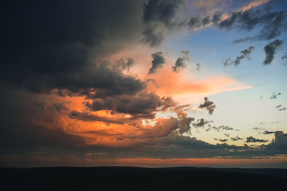 photography of white and black clouds during sunset