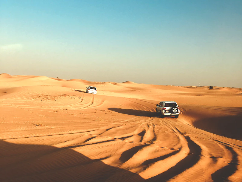 4x4 vehicles driving over sand dunes in the Abu Dhabi desert