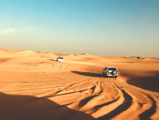 photo of gray vehicle on desert in Abu Dhabi United Arab Emirates